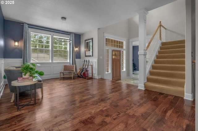 14411 SW 128th Pl, Tigard, OR 97224 - entrance foyer with a decorative wall, decorative columns, stairway, wood finished floors, and wainscoting