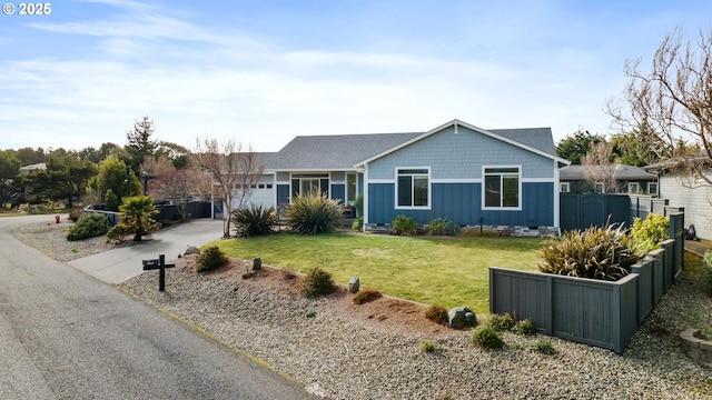 single story home featuring aphalt driveway, board and batten siding, a front yard, fence, and a garage