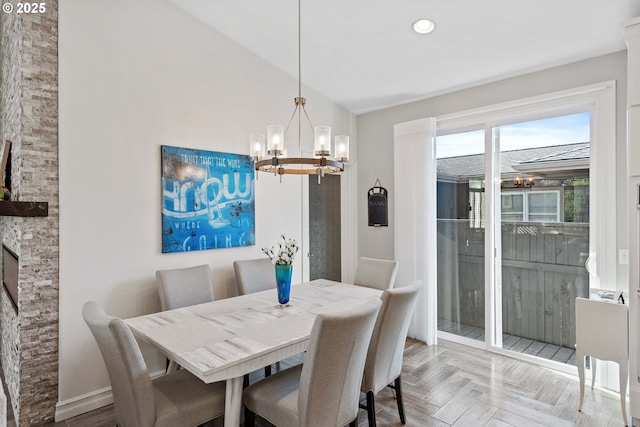 dining area featuring lofted ceiling, baseboards, a chandelier, and recessed lighting