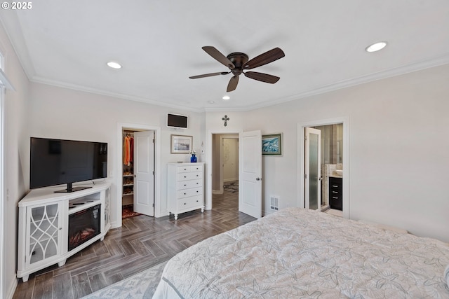 bedroom featuring visible vents, a walk in closet, crown molding, a closet, and recessed lighting