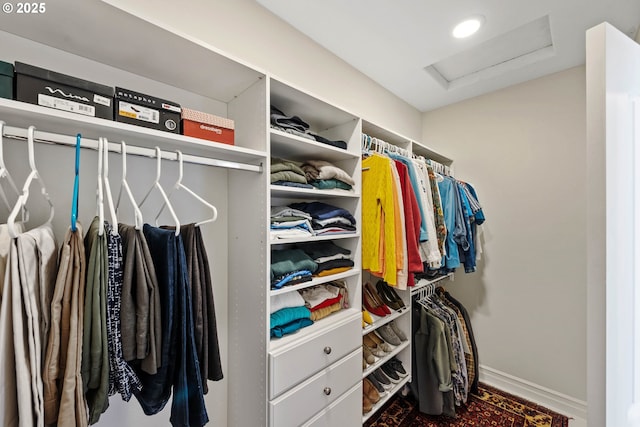 spacious closet featuring attic access