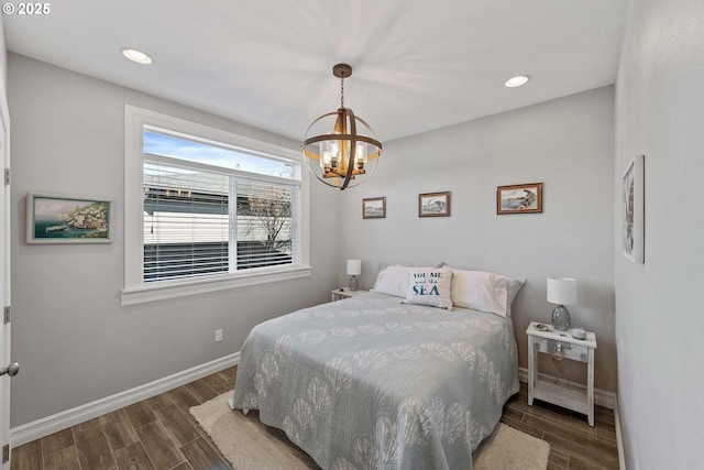 bedroom with recessed lighting, baseboards, a notable chandelier, and wood finish floors