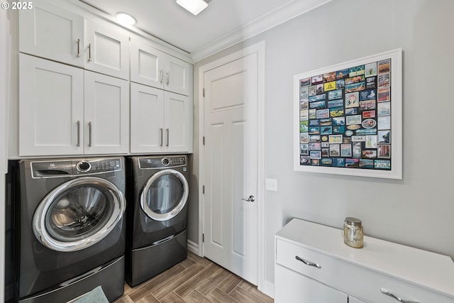 washroom featuring cabinet space and washing machine and dryer