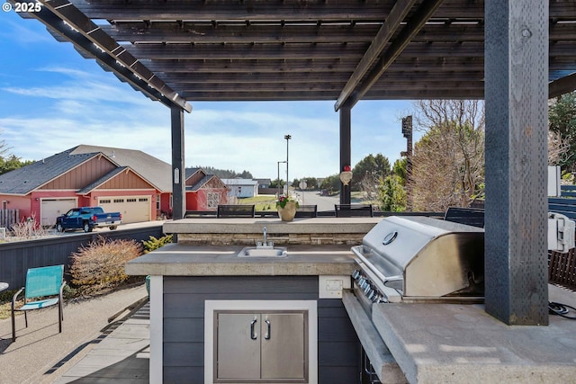 3220 Natalie Way, Bandon, OR 97411 - view of patio / terrace with exterior kitchen, a sink, and a residential view