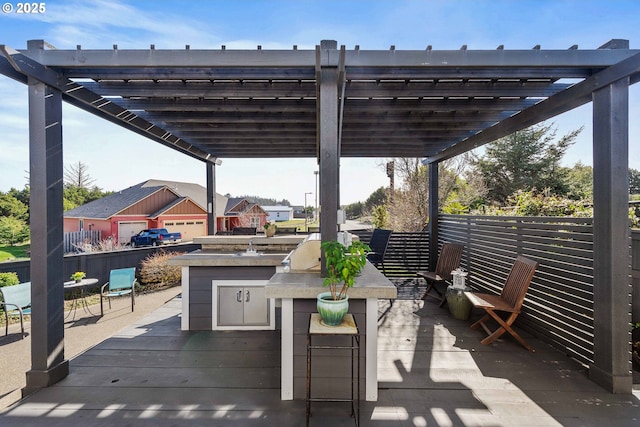 view of patio / terrace with a deck, outdoor dry bar, area for grilling, and a pergola