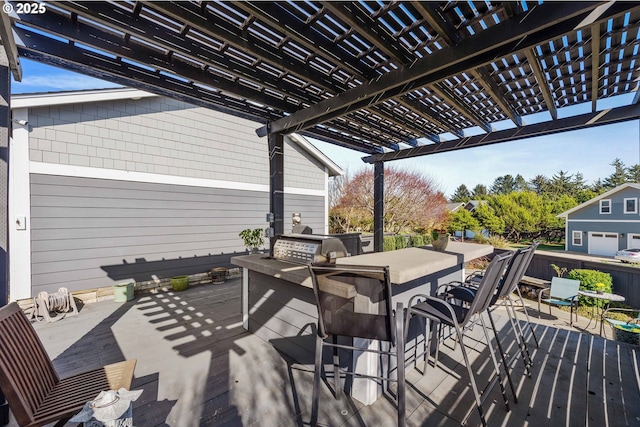 deck with exterior kitchen, outdoor dining space, and a pergola