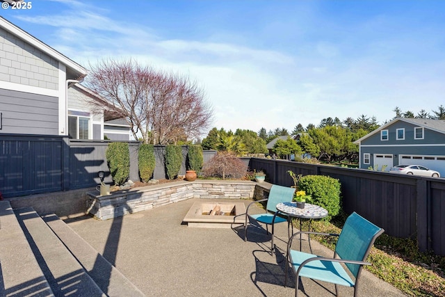 view of patio / terrace with an outdoor fire pit and a fenced backyard