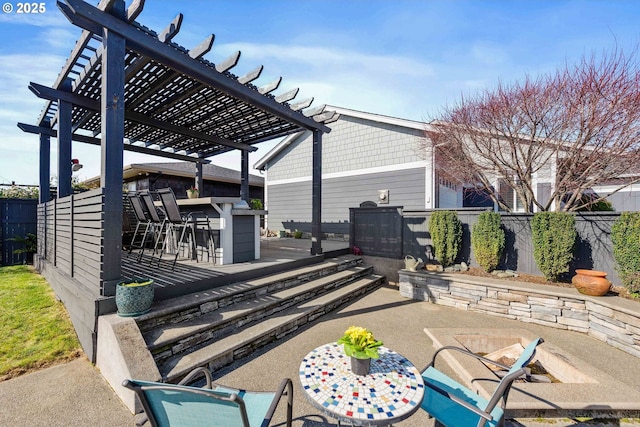 view of patio featuring outdoor dry bar, fence, and a pergola