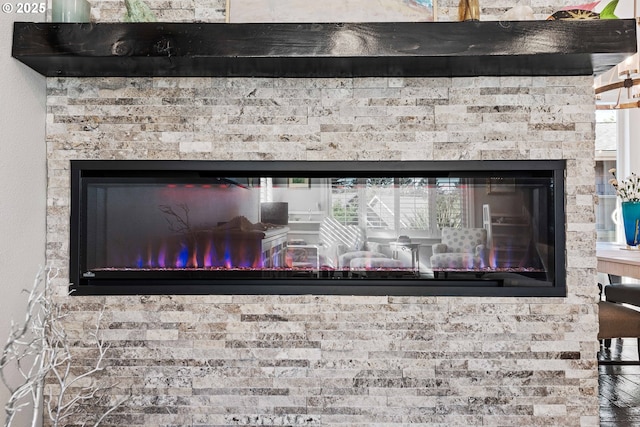 details with a glass covered fireplace