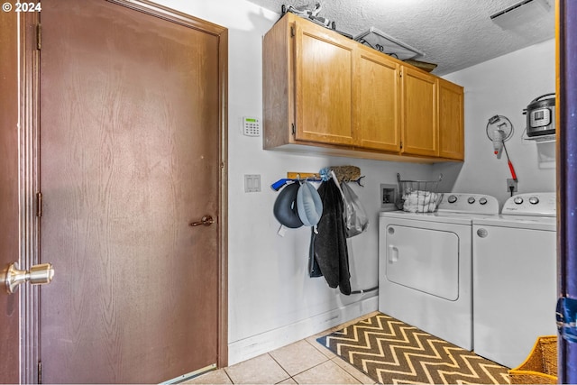 3644 Fall Creek Ct, Keizer, OR 97303 - washroom with cabinet space, tile patterned floors, washing machine and dryer, baseboards, and a textured ceiling
