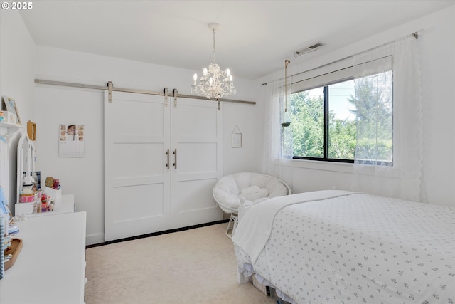 11700 S Makin Ln, Canby, OR 97013 - carpeted bedroom with a barn door, a chandelier, and a closet