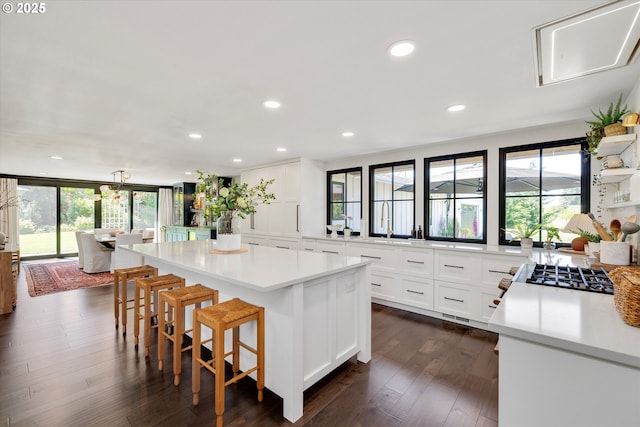 11700 S Makin Ln, Canby, OR 97013 - kitchen featuring a center island, a breakfast bar, light countertops, white cabinets, and recessed lighting