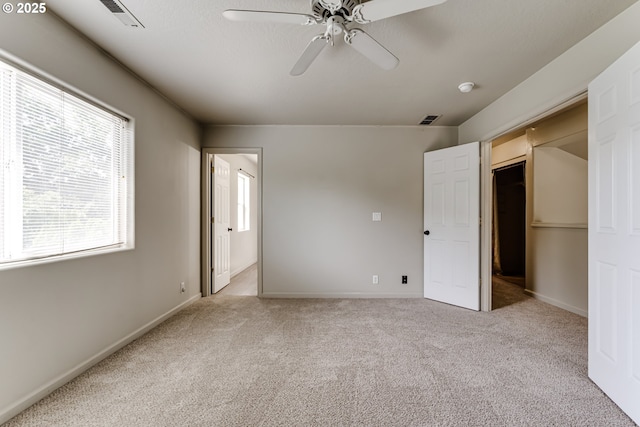 3980 Century Dr, Eugene, OR 97402 - unfurnished bedroom featuring multiple windows, carpet flooring, and a ceiling fan