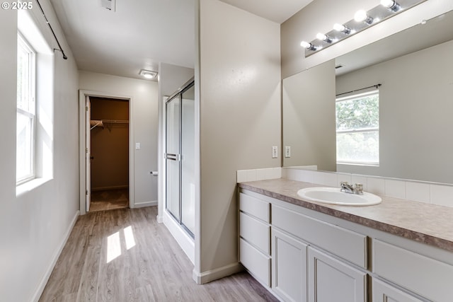 3980 Century Dr, Eugene, OR 97402 - full bath featuring a stall shower, vanity, wood finished floors, and a spacious closet