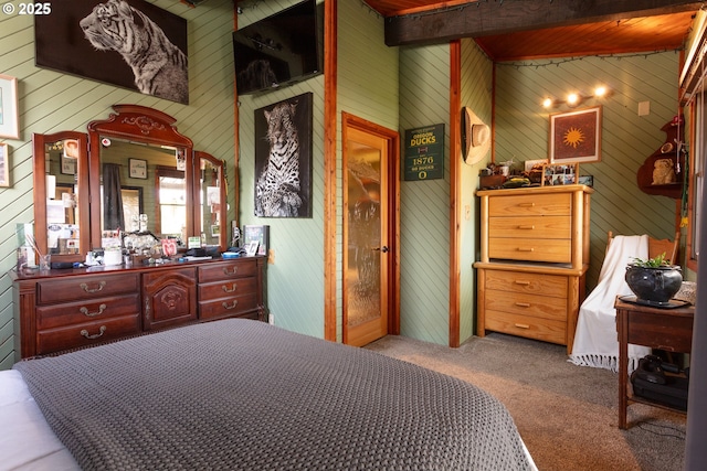 bedroom featuring light carpet and beam ceiling