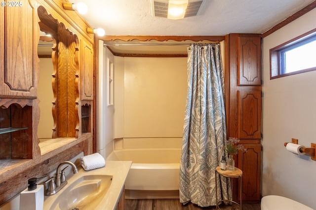 full bathroom featuring a textured ceiling, toilet, vanity, visible vents, and shower / bathtub combination with curtain