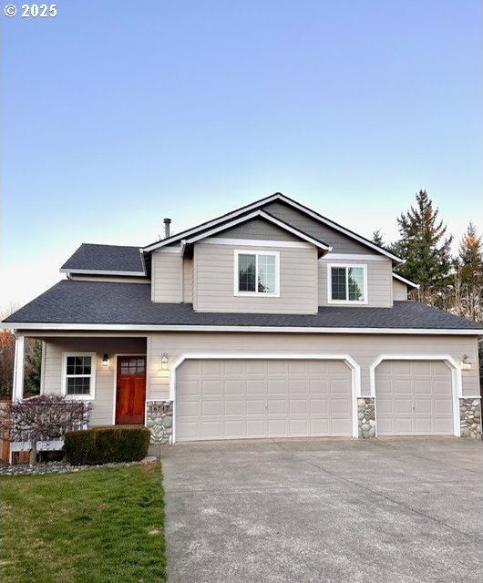 view of front of property with a garage and a front lawn