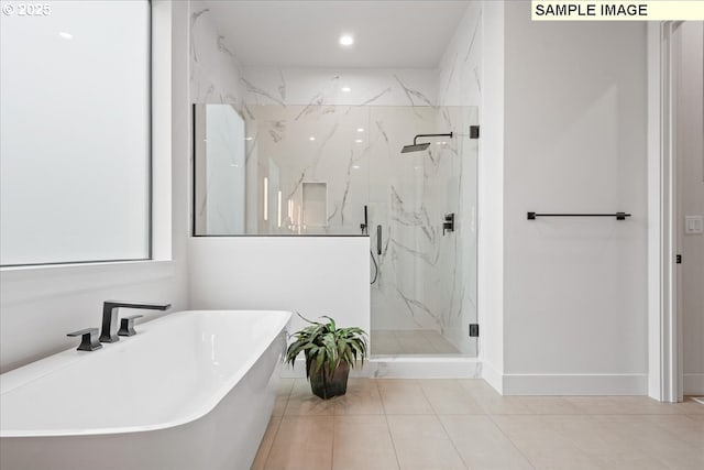 bathroom with a marble finish shower, a soaking tub, tile patterned floors, baseboards, and recessed lighting