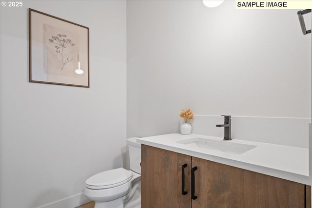 bathroom featuring toilet and vanity