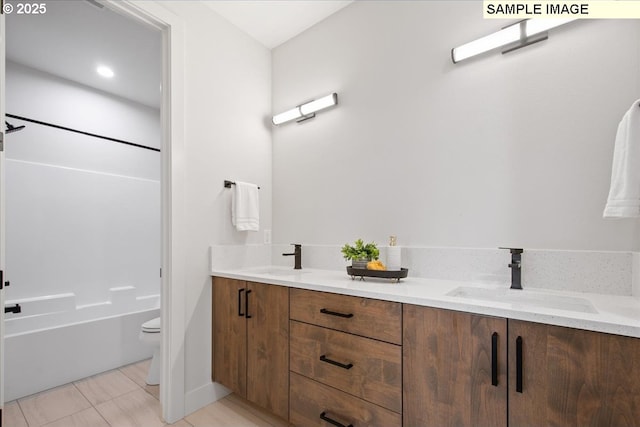 bathroom featuring toilet, double vanity, tile patterned flooring, and shower / bath combination