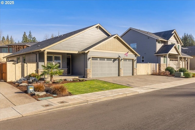 view of front of home featuring cooling unit and a garage