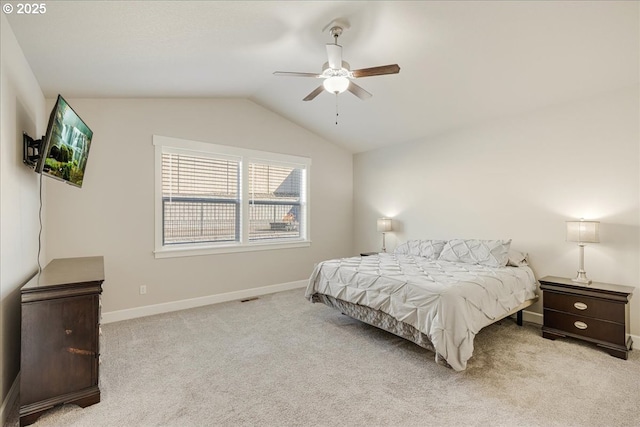 bedroom featuring ceiling fan, vaulted ceiling, and light carpet