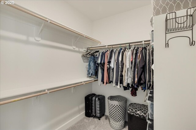 carpeted bedroom with ensuite bathroom, lofted ceiling, and ceiling fan