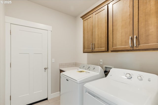 laundry area featuring cabinets and washer and clothes dryer