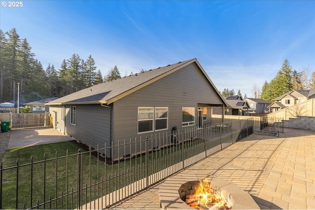 exterior space featuring a yard, a patio area, and a fire pit