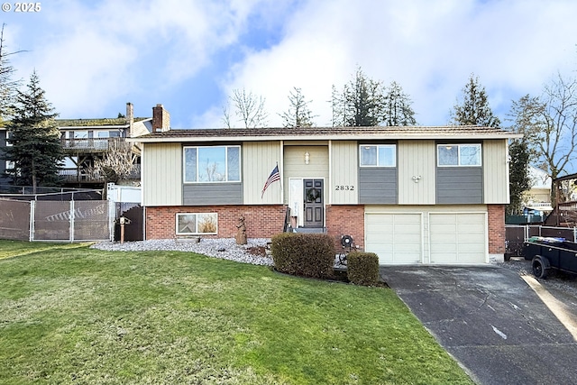 bi-level home with a front lawn and a garage