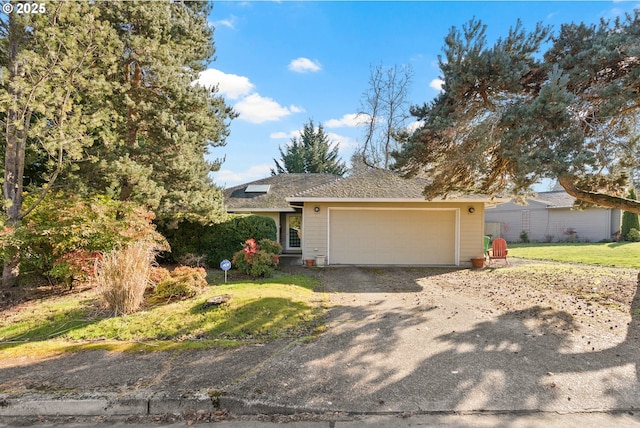 view of front of house featuring a garage and a front lawn