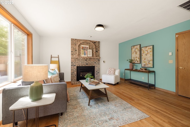 8156 SW 159th Pl, Beaverton, OR 97007 - living area with wood finished floors and a brick fireplace