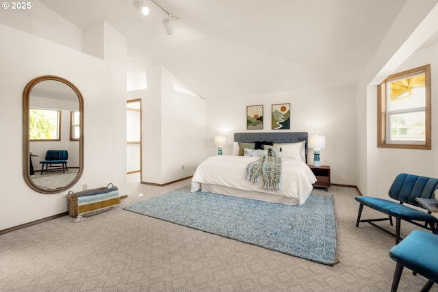8156 SW 159th Pl, Beaverton, OR 97007 - carpeted bedroom with track lighting, lofted ceiling, and baseboards