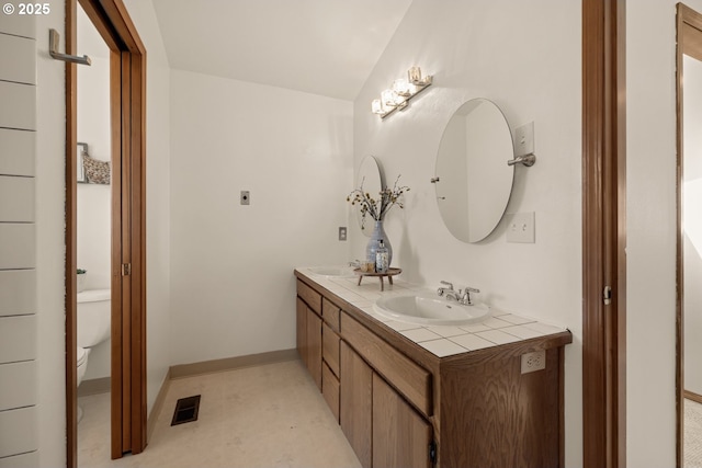 8156 SW 159th Pl, Beaverton, OR 97007 - full bathroom with toilet, double vanity, and baseboards