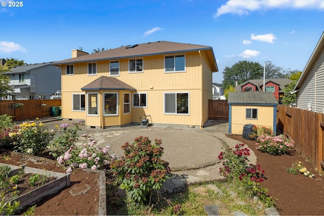 8156 SW 159th Pl, Beaverton, OR 97007 - back of house with a vegetable garden, a patio area, a fenced backyard, and a shingled roof