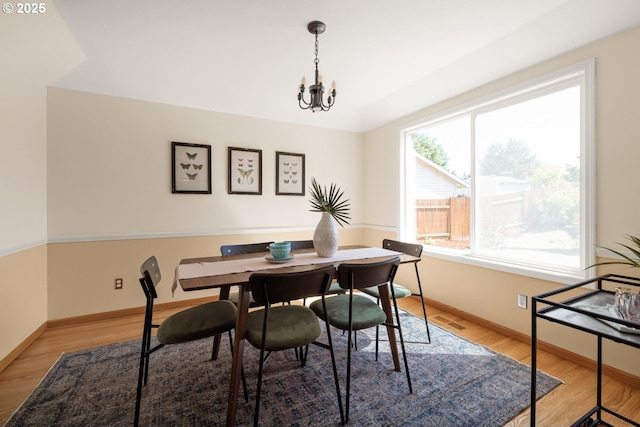 8156 SW 159th Pl, Beaverton, OR 97007 - dining room with a chandelier, light wood finished floors, and baseboards
