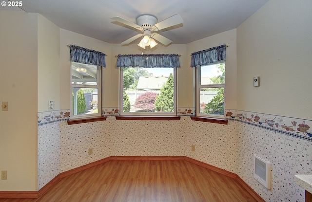 15798 SE 15th St, Vancouver, WA 98683 - empty room with wood finished floors, a wainscoted wall, and a ceiling fan