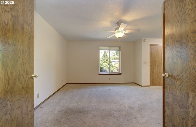 15798 SE 15th St, Vancouver, WA 98683 - empty room with light carpet, a ceiling fan, baseboards, and a textured ceiling
