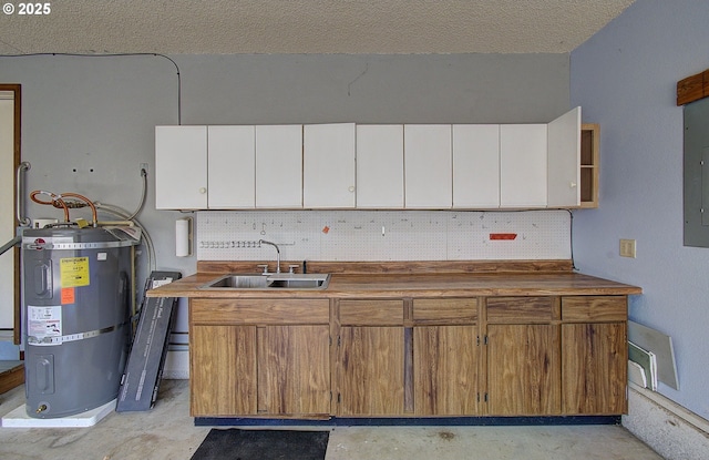 15798 SE 15th St, Vancouver, WA 98683 - kitchen featuring secured water heater, a sink, white cabinetry, open shelves, and a textured ceiling
