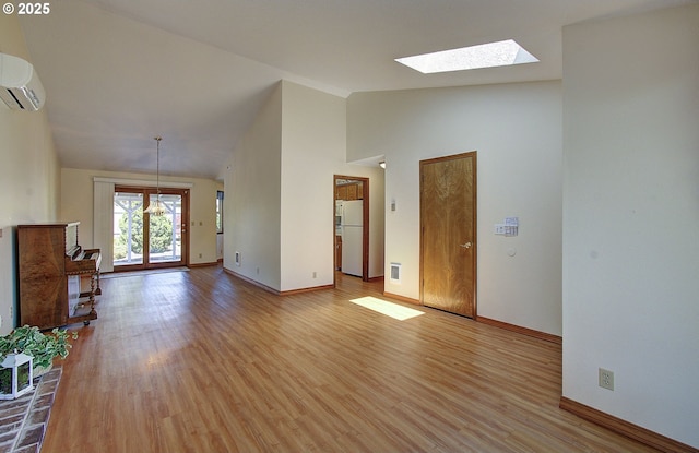 15798 SE 15th St, Vancouver, WA 98683 - unfurnished living room with a skylight, a wall mounted air conditioner, light wood finished floors, baseboards, and high vaulted ceiling