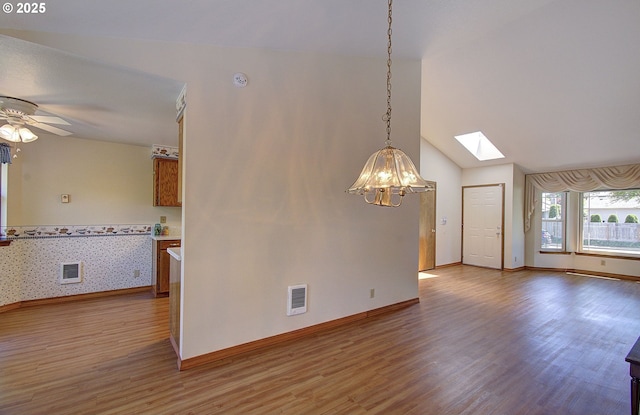 15798 SE 15th St, Vancouver, WA 98683 - empty room with a skylight, a chandelier, wood finished floors, baseboards, and a ceiling fan