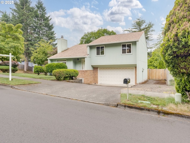 20621 SW Martinazzi Ave, Tualatin, OR 97062 - view of front of property with a chimney, driveway, brick siding, a shingled roof, and a garage