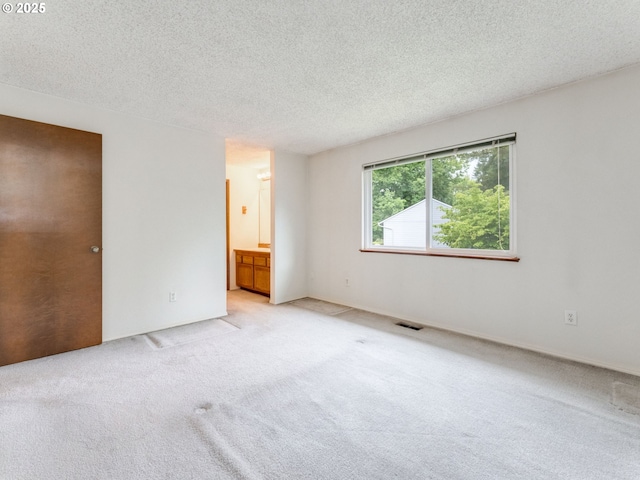 20621 SW Martinazzi Ave, Tualatin, OR 97062 - unfurnished bedroom with light carpet, a textured ceiling, and ensuite bathroom