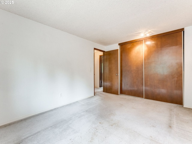20621 SW Martinazzi Ave, Tualatin, OR 97062 - unfurnished bedroom featuring light colored carpet, a closet, and a textured ceiling