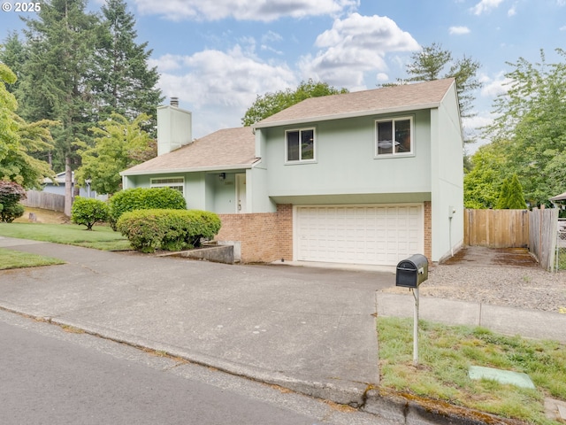 20621 SW Martinazzi Ave, Tualatin, OR 97062 - view of front of property featuring a shingled roof, driveway, a chimney, brick siding, and a garage