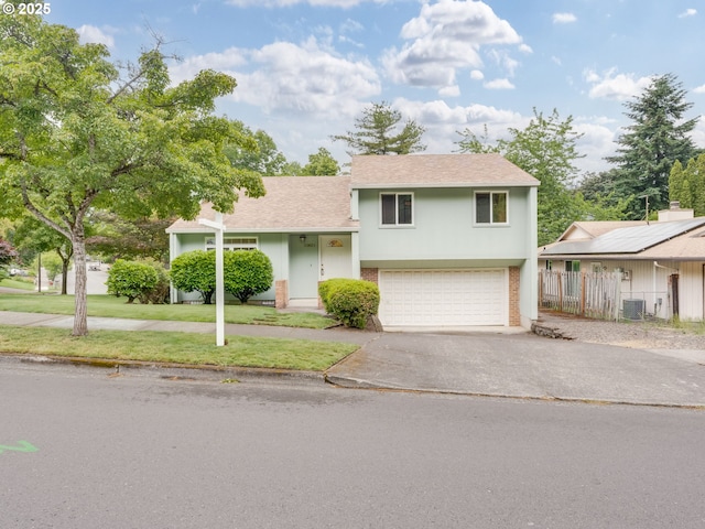 20621 SW Martinazzi Ave, Tualatin, OR 97062 - view of front facade with asphalt driveway, an attached garage, cooling unit, and roof with shingles