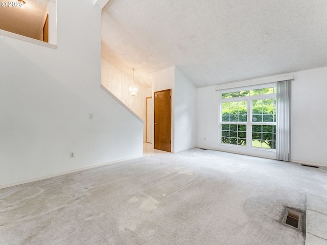 20621 SW Martinazzi Ave, Tualatin, OR 97062 - unfurnished living room featuring light colored carpet, a textured ceiling, and a chandelier