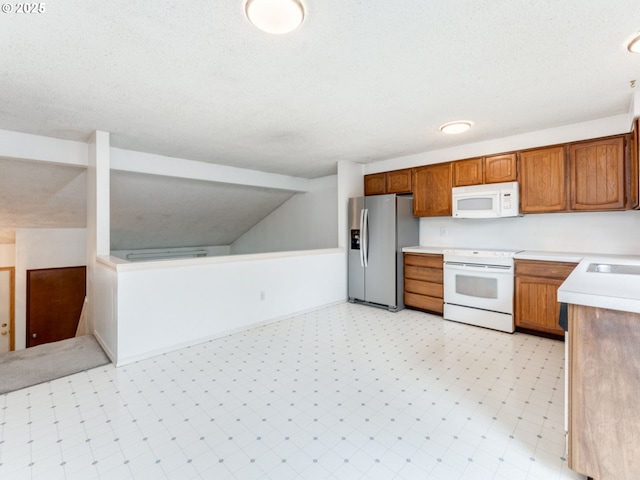 20621 SW Martinazzi Ave, Tualatin, OR 97062 - kitchen with white appliances, light countertops, brown cabinets, and light flooring