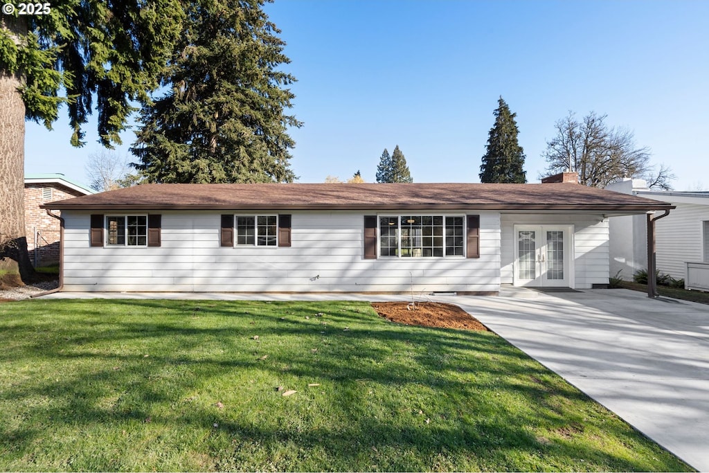 single story home with a front yard and french doors