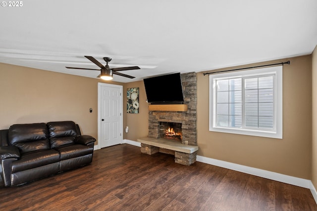 living room with ceiling fan, a fireplace, and dark hardwood / wood-style flooring